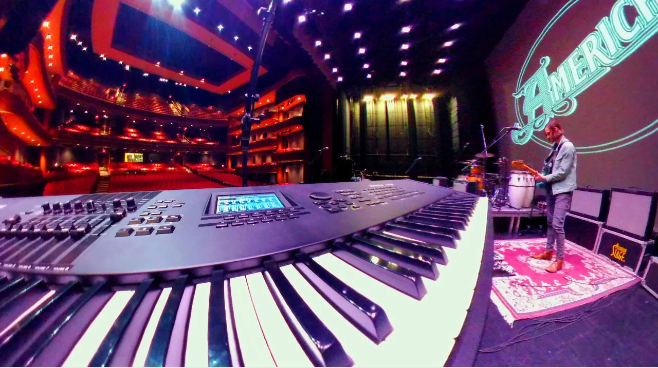 Musician playing a keyboard on stage Musician playing a keyboard on stage