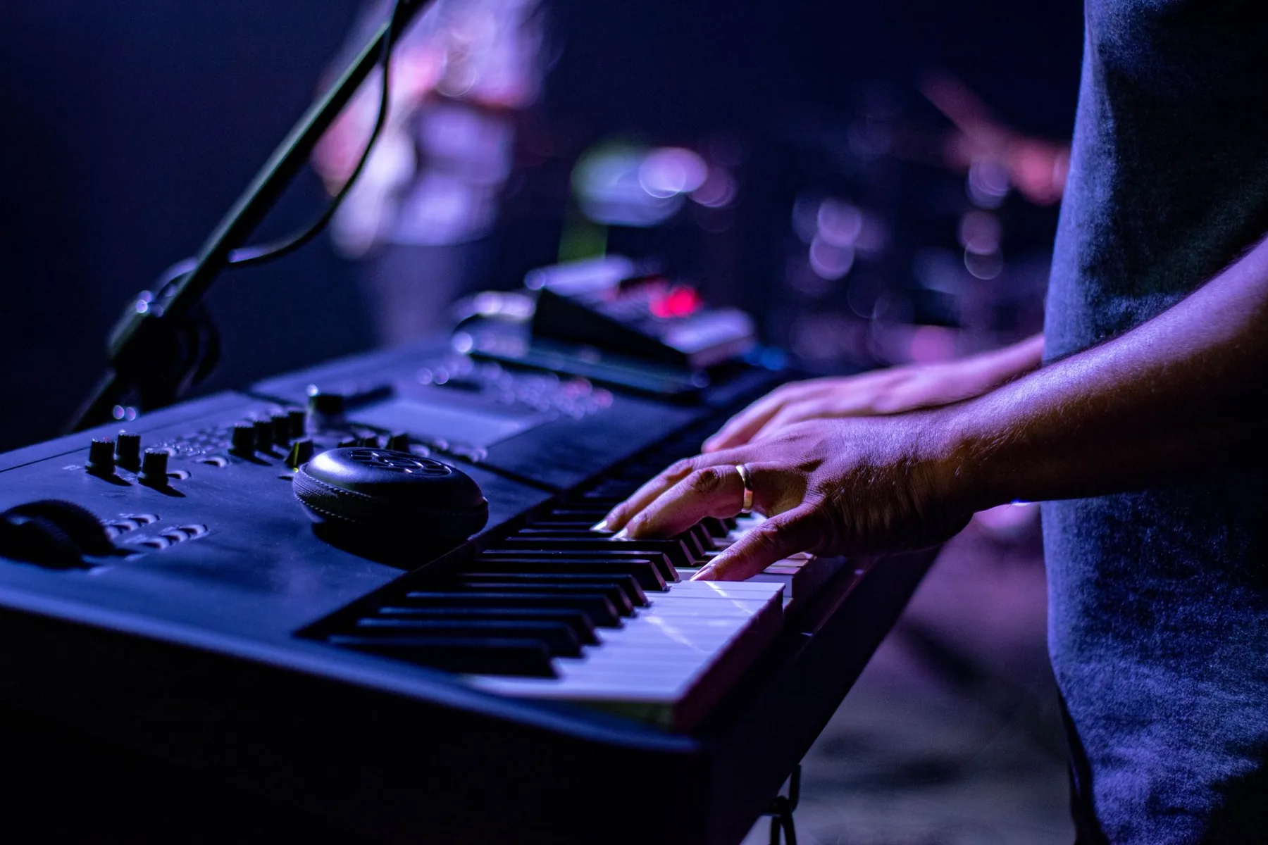 Musician playing a synthesizer on stage