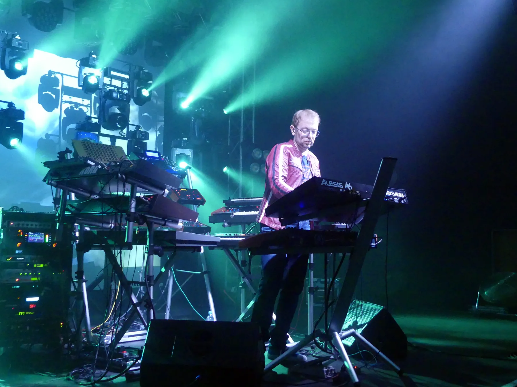 Musician playing synthesizers on stage