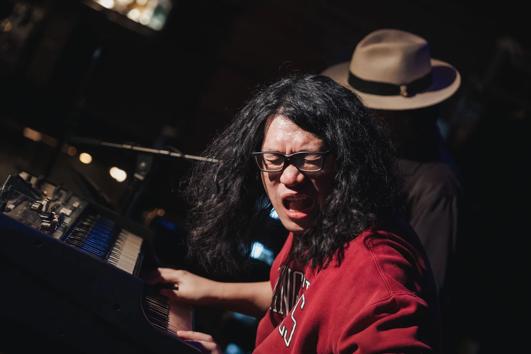 Musician playing a synthesizer Musician playing a synthesizer